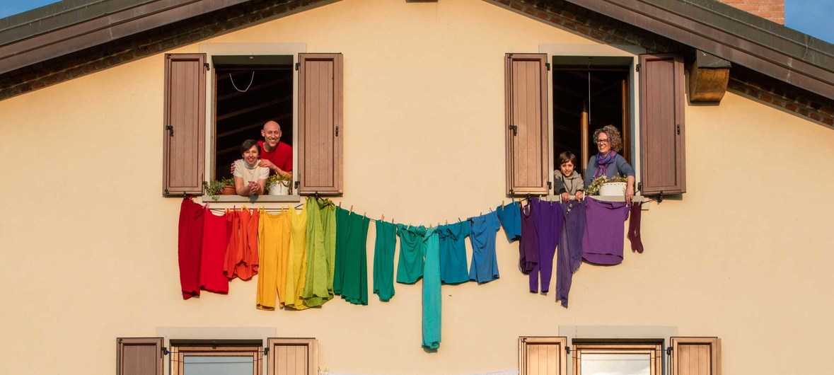 People self-quarantined in Italy make a show of solidarity.