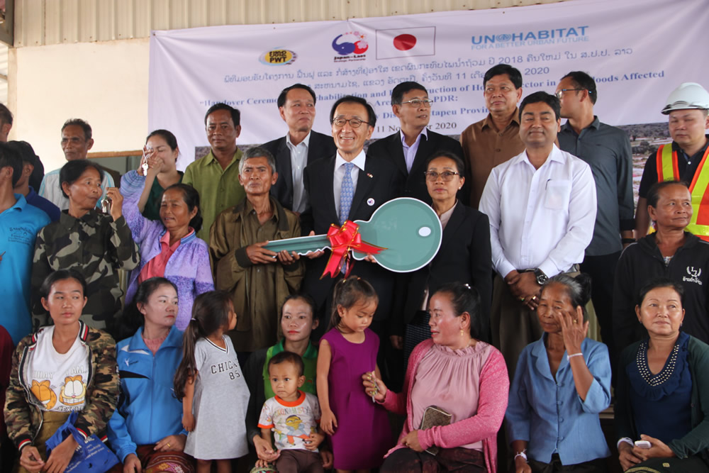 Japanese Ambassador with a symbolic house key as the newly constructed houses were handed over to the people